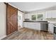 Bright kitchen featuring white cabinets, stainless steel appliances, and a sliding barn door at 2009 Auten Rd, Gastonia, NC 28054