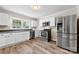 Kitchen featuring stainless steel appliances, white cabinets, and laminate flooring at 2009 Auten Rd, Gastonia, NC 28054