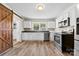 Bright kitchen featuring shaker cabinets, stainless appliances, and vinyl floors at 2009 Auten Rd, Gastonia, NC 28054