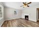 Bright living room featuring luxury vinyl floors, a ceiling fan, and fireplace at 2009 Auten Rd, Gastonia, NC 28054