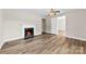 Bright living room showcasing vinyl plank floors, a fireplace, and white trim at 2009 Auten Rd, Gastonia, NC 28054