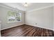 Bright bedroom with hardwood floors, trim, and a large window providing natural light at 2028 Covered Bridge Ct, Rock Hill, SC 29732