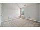 This bedroom has neutral walls, trim and carpet with a window allowing natural light at 2028 Covered Bridge Ct, Rock Hill, SC 29732