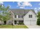 Charming two-story home featuring a stone facade, gray siding, and a well-manicured lawn at 2028 Covered Bridge Ct, Rock Hill, SC 29732
