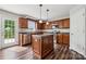 Well-lit kitchen featuring hardwood floors, an island, and stainless steel appliances at 2028 Covered Bridge Ct, Rock Hill, SC 29732