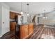 Open kitchen boasts a center island, stainless steel appliances, wood cabinets, and hardwood floors at 2028 Covered Bridge Ct, Rock Hill, SC 29732