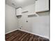 Laundry room with white cabinets, shelves, and wood-look flooring at 2028 Covered Bridge Ct, Rock Hill, SC 29732