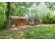 Brick house with a deck in a spacious, tree-filled backyard at 205 E Cleveland Ave, Bessemer City, NC 28016