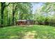 Green backyard featuring a brick house with a wood deck and grassy lawn at 205 E Cleveland Ave, Bessemer City, NC 28016