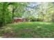 Spacious backyard featuring a brick house with a wooden deck, perfect for outdoor activities and relaxation at 205 E Cleveland Ave, Bessemer City, NC 28016