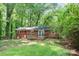 A lush backyard featuring a brick home and a charming deck at 205 E Cleveland Ave, Bessemer City, NC 28016