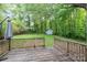 Backyard view from a wooden deck surrounded by lush greenery at 205 E Cleveland Ave, Bessemer City, NC 28016