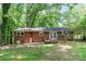 The backyard includes a brick house and a wooden deck at 205 E Cleveland Ave, Bessemer City, NC 28016