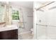 Bright bathroom with vanity sink, medicine cabinet and walk-in shower with glass door at 205 E Cleveland Ave, Bessemer City, NC 28016