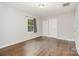 Bright bedroom featuring hardwood floors, one window with patterned curtains, and closet space at 205 E Cleveland Ave, Bessemer City, NC 28016