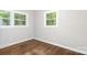 Well-lit bedroom with hardwood floors and windows overlooking greenery at 205 E Cleveland Ave, Bessemer City, NC 28016