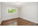 Bright bedroom featuring hardwood floors, one window with a beautiful nature view and neutral walls at 205 E Cleveland Ave, Bessemer City, NC 28016