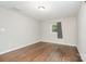 Neutral colored bedroom featuring hardwood floors, one window with curtain and overhead lighting at 205 E Cleveland Ave, Bessemer City, NC 28016