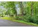 A home nestled among mature trees, offering privacy and a serene setting at 205 E Cleveland Ave, Bessemer City, NC 28016