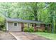 A well-kept home with a mix of brick and siding, surrounded by mature trees at 205 E Cleveland Ave, Bessemer City, NC 28016