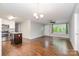 Open-concept living space with hardwood flooring, adjacent to an updated kitchen at 205 E Cleveland Ave, Bessemer City, NC 28016