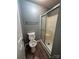 This bathroom has a toilet and a walk-in shower with a sliding door, along with matching flooring at 2106 S Main St, Kannapolis, NC 28081