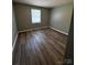 Bedroom with wood flooring, gray walls and window for natural light at 2106 S Main St, Kannapolis, NC 28081