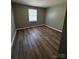 Bedroom with wood flooring, gray walls and window for natural light at 2106 S Main St, Kannapolis, NC 28081