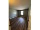 This bedroom features lovely dark hardwood floors and a bright window for natural light at 2106 S Main St, Kannapolis, NC 28081