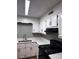 Well-lit kitchen featuring gray walls, white cabinets and counter tops, and modern appliances at 2106 S Main St, Kannapolis, NC 28081