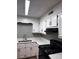 Well-lit kitchen featuring gray walls, white cabinets and counter tops, and modern appliances at 2106 S Main St, Kannapolis, NC 28081