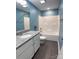 Stylish bathroom featuring blue walls, granite countertop, and a tub with shower at 212 Old Centergrove Rd, Kannapolis, NC 28083