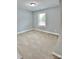 Neutral bedroom featuring carpet floors and natural light from the window at 212 Old Centergrove Rd, Kannapolis, NC 28083