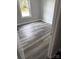 Neat bedroom featuring gray wood-look flooring, white molding, and natural light at 212 Old Centergrove Rd, Kannapolis, NC 28083