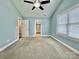 Bedroom with neutral carpet, connecting door to the bathroom, and a well-lit window at 212 Old Centergrove Rd, Kannapolis, NC 28083