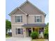 Charming two-story home featuring neutral siding, gray shutters and a cozy front porch at 212 Old Centergrove Rd, Kannapolis, NC 28083