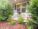 Inviting front porch with white rocking chairs and beautiful flower bed at 212 Old Centergrove Rd, Kannapolis, NC 28083