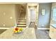 Modern kitchen featuring granite counters, a central island, and stairs leading to the next level at 212 Old Centergrove Rd, Kannapolis, NC 28083