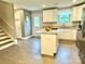 Well-lit kitchen with white cabinets, granite countertops, stainless steel appliances, and a central island at 212 Old Centergrove Rd, Kannapolis, NC 28083