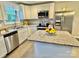 Bright kitchen with white cabinetry, granite countertops, stainless steel appliances, and center island at 212 Old Centergrove Rd, Kannapolis, NC 28083