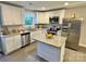 Modern kitchen with white cabinets, granite countertops, stainless steel appliances, and functional island at 212 Old Centergrove Rd, Kannapolis, NC 28083
