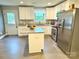 Spacious kitchen featuring white cabinets, granite countertops, stainless steel appliances, and island at 212 Old Centergrove Rd, Kannapolis, NC 28083