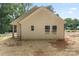 Side view of a home featuring beige siding and white window trim at 217 E Division Ave, Salisbury, NC 28144