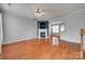 Spacious living room featuring hardwood floors, a fireplace, and an open layout to the dining area at 228 Dawn Mist Ln, Fort Mill, SC 29708