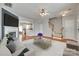 Cozy living room with a fireplace, hardwood floors, neutral-toned furniture, and seamless flow to the kitchen at 228 Dawn Mist Ln, Fort Mill, SC 29708