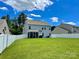 Large backyard featuring a white fence, expansive lawn, and a view of the rear of the house at 2311 Verde Creek Rd, Charlotte, NC 28214