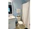 Bright, freshly painted bathroom with new toilet and shower with decorative curtain at 2311 Verde Creek Rd, Charlotte, NC 28214