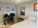 Neutral bedroom with a bed and posters on the wall and desk to the left at 2311 Verde Creek Rd, Charlotte, NC 28214