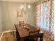 Inviting dining room featuring a chandelier, wooden table with seating for four, and patterned curtains at 2311 Verde Creek Rd, Charlotte, NC 28214