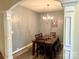 Elegant dining room with a chandelier, wood table, decorative columns, and stylish accents at 2311 Verde Creek Rd, Charlotte, NC 28214
